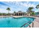 Community pool with deck, lounge chairs, and tropical landscaping near the clubhouse at 1104 Yosemite Dr, Englewood, FL 34223