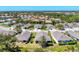 A rear exterior view featuring a covered patio, neat landscaping, and well-maintained lawn at 1104 Yosemite Dr, Englewood, FL 34223
