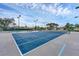 Community tennis court with lighting, nets, and ample space for players and spectators at 1104 Yosemite Dr, Englewood, FL 34223