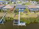 Aerial view featuring a waterfront property with a screened pool, private dock, and boat lift at 14564 Gaspar Loop, Port Charlotte, FL 33981