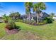 Spacious backyard featuring a screened-in lanai, lush landscaping, and access to a private dock at 14564 Gaspar Loop, Port Charlotte, FL 33981