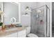 Bright bathroom featuring granite vanity, glass shower, and modern neutral finishes at 14564 Gaspar Loop, Port Charlotte, FL 33981