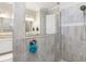Spa bathroom features tile surround shower, vanity and framed mirror at 14564 Gaspar Loop, Port Charlotte, FL 33981