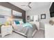 Cozy bedroom with a large TV, neutral color scheme, and bright blue accents at 14564 Gaspar Loop, Port Charlotte, FL 33981