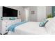 Comfortable bedroom featuring a cozy bed, dresser, and a mounted television at 14564 Gaspar Loop, Port Charlotte, FL 33981