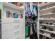 Organized walk-in closet with shelving, drawers and ample storage space for clothes and accessories at 14564 Gaspar Loop, Port Charlotte, FL 33981