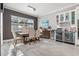 Elegant dining area with a bar featuring wine refrigerator and beverage storage at 14564 Gaspar Loop, Port Charlotte, FL 33981