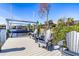Dockside seating area featuring Adirondack chairs and a boat lift, perfect for waterfront relaxation at 14564 Gaspar Loop, Port Charlotte, FL 33981