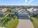 Beautiful home with a well-manicured lawn, mature landscaping, and a brick driveway at 14564 Gaspar Loop, Port Charlotte, FL 33981