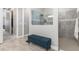 The tiled hallway leading into the tiled glass shower, with a bench along the wall at 14564 Gaspar Loop, Port Charlotte, FL 33981