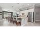 Bright, modern kitchen featuring stainless steel appliances, an island with bar seating, and tile flooring at 14564 Gaspar Loop, Port Charlotte, FL 33981