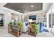 Relax in this stylish living room featuring custom shelving, a modern ceiling fan, and plush seating at 14564 Gaspar Loop, Port Charlotte, FL 33981