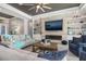 Cozy living room featuring a modern fireplace, built-in shelves, and comfortable seating at 14564 Gaspar Loop, Port Charlotte, FL 33981