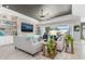 Comfortable living room showcasing built-in shelving, a stylish ceiling fan, and ample natural light at 14564 Gaspar Loop, Port Charlotte, FL 33981