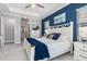 Stylish main bedroom with tray ceiling, ceiling fan, and a blue accent wall at 14564 Gaspar Loop, Port Charlotte, FL 33981