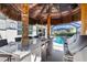 Covered tiki bar area with seating near a pool, perfect for entertaining guests and enjoying the outdoors at 14564 Gaspar Loop, Port Charlotte, FL 33981