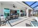 Covered patio with dining and seating area, ceiling fan, and access to the pool at 14564 Gaspar Loop, Port Charlotte, FL 33981