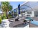 Seating and chaise lounges, next to pool and tiki bar, surrounded by tropical landscaping, great for relaxation at 14564 Gaspar Loop, Port Charlotte, FL 33981