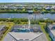 An aerial view of a screened-in pool, hot tub and patio in a beautiful backyard setting at 14564 Gaspar Loop, Port Charlotte, FL 33981