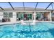 Backyard swimming pool with sun loungers for relaxing and enjoying the Florida sunshine at 14564 Gaspar Loop, Port Charlotte, FL 33981