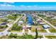 Expansive aerial view of a waterfront community with canals and houses, capturing a serene coastal living environment at 14810 Ingraham Blvd, Port Charlotte, FL 33981
