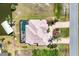 Aerial view of waterfront home with screened pool, boat dock, lush landscaping and circular driveway at 14810 Ingraham Blvd, Port Charlotte, FL 33981
