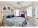 Bedroom featuring a comfortable bed, ceiling fan, and a mounted television for relaxation at 14810 Ingraham Blvd, Port Charlotte, FL 33981
