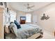 Cozy bedroom featuring ceiling fan, plush bedding, and nautical-themed décor at 14810 Ingraham Blvd, Port Charlotte, FL 33981