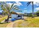 Covered boat dock with lift on lushly landscaped waterfront property with winding sidewalks at 14810 Ingraham Blvd, Port Charlotte, FL 33981