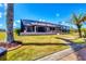 Exterior of screened-in pool and patio area with tropical landscaping and walkway to boat dock at 14810 Ingraham Blvd, Port Charlotte, FL 33981