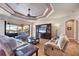 Comfortable living room featuring tray ceilings, tile floors, and large windows with views of the pool area at 14810 Ingraham Blvd, Port Charlotte, FL 33981
