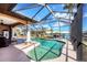 Private screened-in pool with waterfront views, complemented by outdoor seating and lush landscaping at 14810 Ingraham Blvd, Port Charlotte, FL 33981