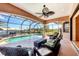 Screened-in patio with pool and spa, offering stunning waterfront views and comfortable seating at 14810 Ingraham Blvd, Port Charlotte, FL 33981