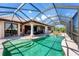 Large screened-in pool with waterfront views, lounging area, and access to the outdoor living space at 14810 Ingraham Blvd, Port Charlotte, FL 33981