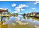 Scenic view of the canal showcasing calm waters and boat docks with covered boat lifts amidst beautiful homes at 14810 Ingraham Blvd, Port Charlotte, FL 33981