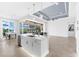 Gourmet kitchen featuring an island with a sink, stainless steel appliances, and an adjacent dining area at 15380 Alsask Cir, Port Charlotte, FL 33981