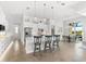 Open kitchen with center island, stainless appliances, and dining area at 15380 Alsask Cir, Port Charlotte, FL 33981