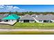 A view of modern home backyards with a tranquil pond and landscaping at 1607 Laurel Brook Ln, Port Charlotte, FL 33953