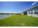 A well-maintained backyard with a view of a serene pond behind the home at 1607 Laurel Brook Ln, Port Charlotte, FL 33953