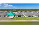 Backyards of homes by a pond with fresh landscaping in a modern community at 1607 Laurel Brook Ln, Port Charlotte, FL 33953