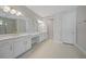 Open bathroom featuring double sinks with white countertops and a tile floor at 1607 Laurel Brook Ln, Port Charlotte, FL 33953