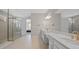 A luxurious bathroom features double vanities, and a glass-enclosed shower at 1607 Laurel Brook Ln, Port Charlotte, FL 33953