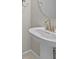 A pedestal sink featuring a round mirror and modern fixtures at 1607 Laurel Brook Ln, Port Charlotte, FL 33953