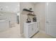 A modern butler's pantry with white cabinets, open shelving, and quartz countertops at 1607 Laurel Brook Ln, Port Charlotte, FL 33953