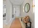 Inviting entryway with neutral decor, stylish mirror, and convenient bench seating at 1607 Laurel Brook Ln, Port Charlotte, FL 33953