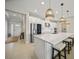 Bright kitchen features a large island with seating, stainless steel appliances, and modern lighting at 1607 Laurel Brook Ln, Port Charlotte, FL 33953