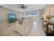 Cozy living room with a sliding glass door that offers a scenic view of the lake at 1607 Laurel Brook Ln, Port Charlotte, FL 33953