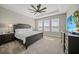 Tranquil primary bedroom with tray ceiling, ceiling fan, and large windows at 1607 Laurel Brook Ln, Port Charlotte, FL 33953