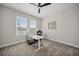 Bright office space with white desk, modern chair, and ample natural light from two large windows at 1607 Laurel Brook Ln, Port Charlotte, FL 33953
