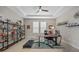 Cozy office area featuring large shelving unit, desk and treadmill at 1607 Laurel Brook Ln, Port Charlotte, FL 33953